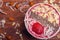 Bowl of fresh acÌ§aiÌ garnished with strawberries and granola on a rustic wood table. AcÌ§aiÌ bowls from above